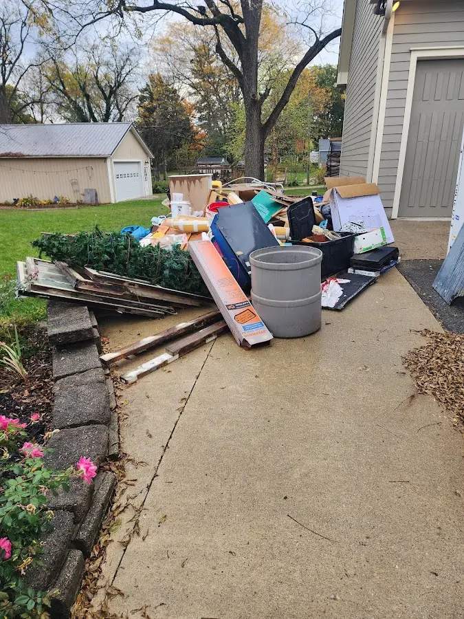 Dumpster being loaded with debris for Commercial Dumpster Rental in Bath